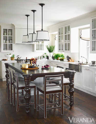 Modern and Light Kitchen with dark wood furnishings and fabulous pendant lights www.pattersondecoratinggroup.com/blog