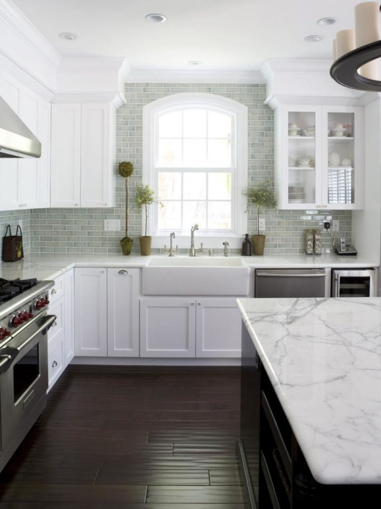 Cottage Style Kitchen with Calcutta Marble and a Farmhouse Sink www.PattersonDecoratingGroup.com/blog