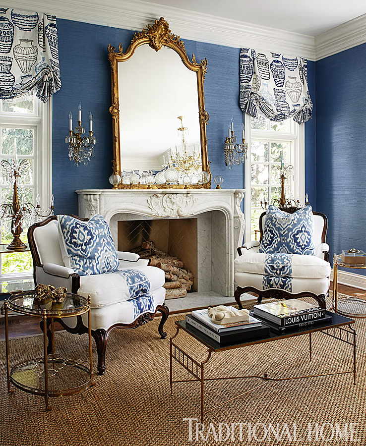 Traditional Living Space with blue wall covering and gold mirror blue rooms www.pattersondecoratinggroup.com/blog