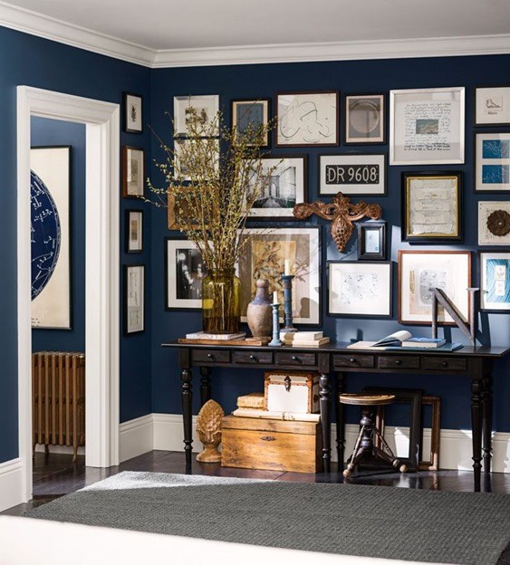 Navy Blue Wall with Gallery Art Blue Rooms www.PattersonDecoratingGroup.com/blog