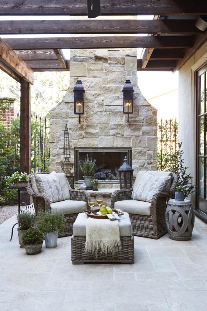 Country French Patio with limestone fireplace www.PattersonDecoratingGroup.com/blog