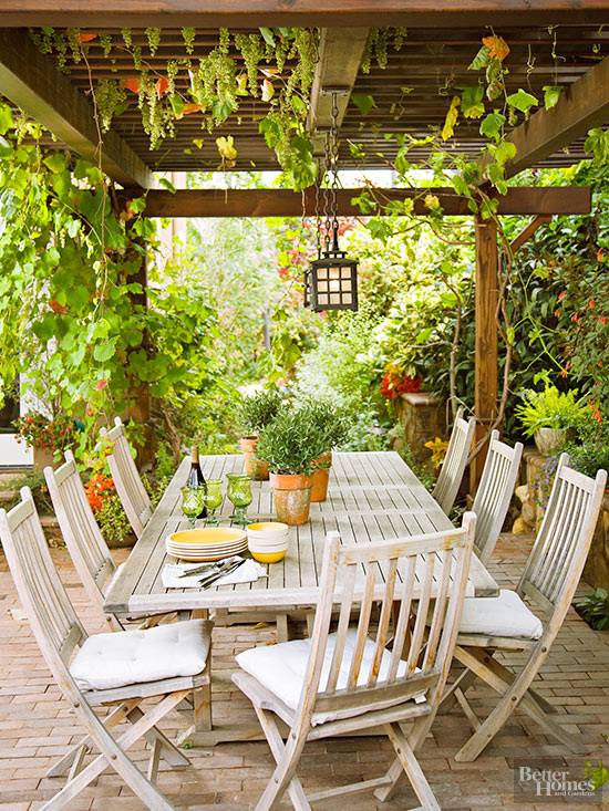 Outdoor dining area defined by a pergola that provides shade on hot sunny days www.PattersonDecoratingGroup.com/blog