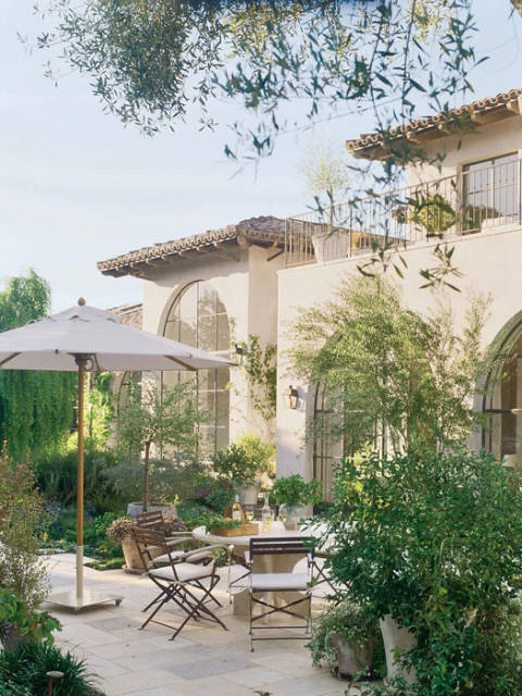 California home with vintage chairs and umbrella by Santa Barbara Designs www.PattersonDecoratingGroup.com/blog