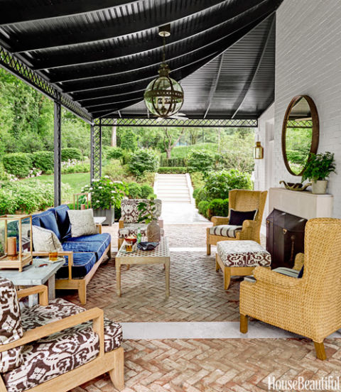 Cozy Nashville porch that is used year round thanks to an outdoor fireplace www.PattersonDecoratingGroup.com/blog