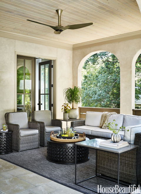 Cozy loggia with wicker seating and super cool fan www.PattersonDecoratingGroup.com/blog