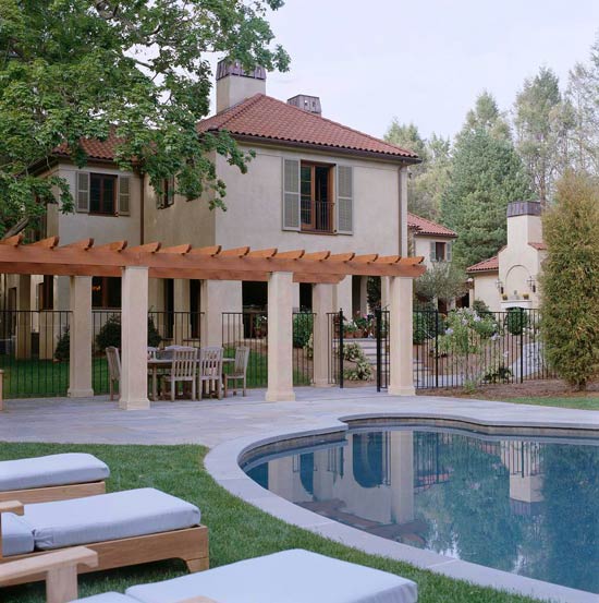 Shapely pool adjoins the outdoor kitchen and courtyard www.PattersonDecoratingGroup.com/blog