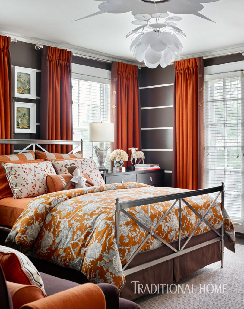 Bright Orange drapes with a contrasting fabric banded along the vertical edge www.PattersonDecoratingGroup.com/blog