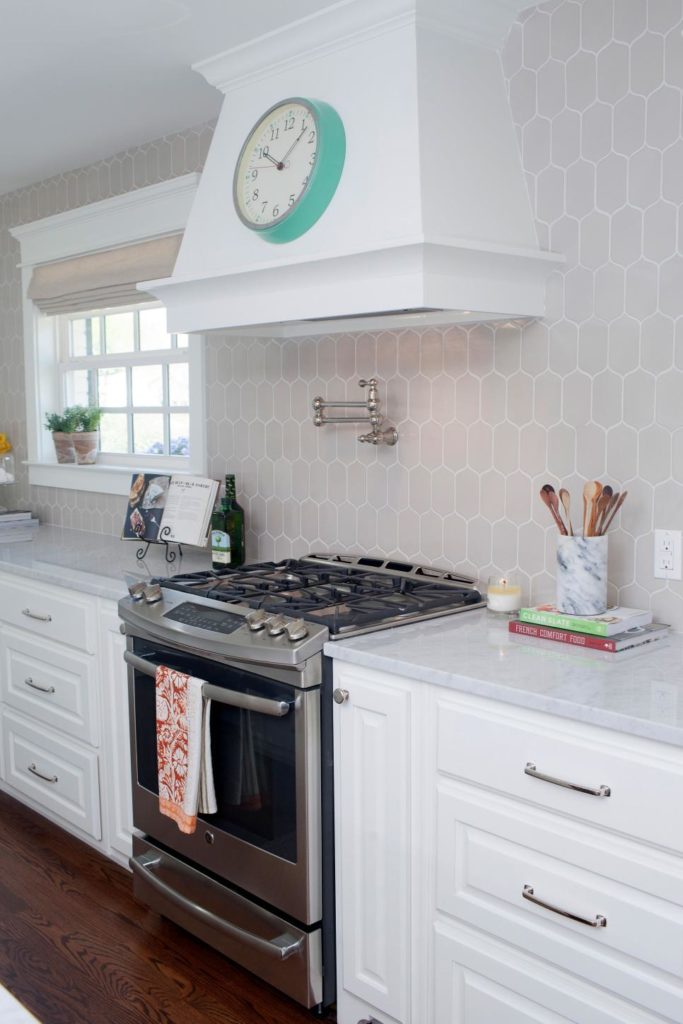 Great family kitchen with marble countertops and gas range www.PattersonDecoratingGroup.com/blog