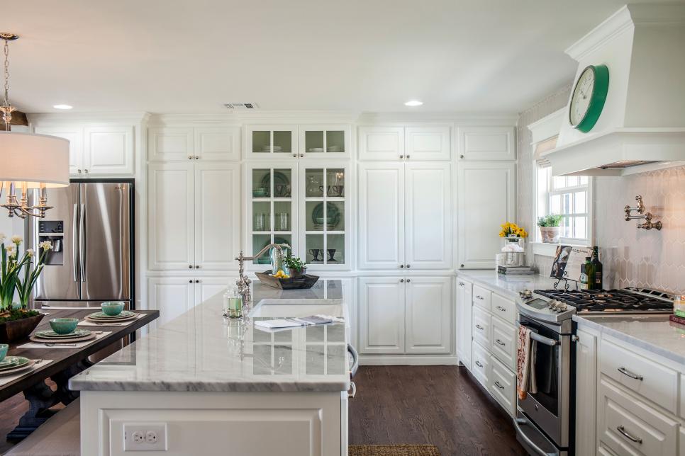 White cabinets, wood floors and marble countertops make for a winning combination in the Fixer Upper Kitchen www.PattersonDecoratingGroup.com/blog