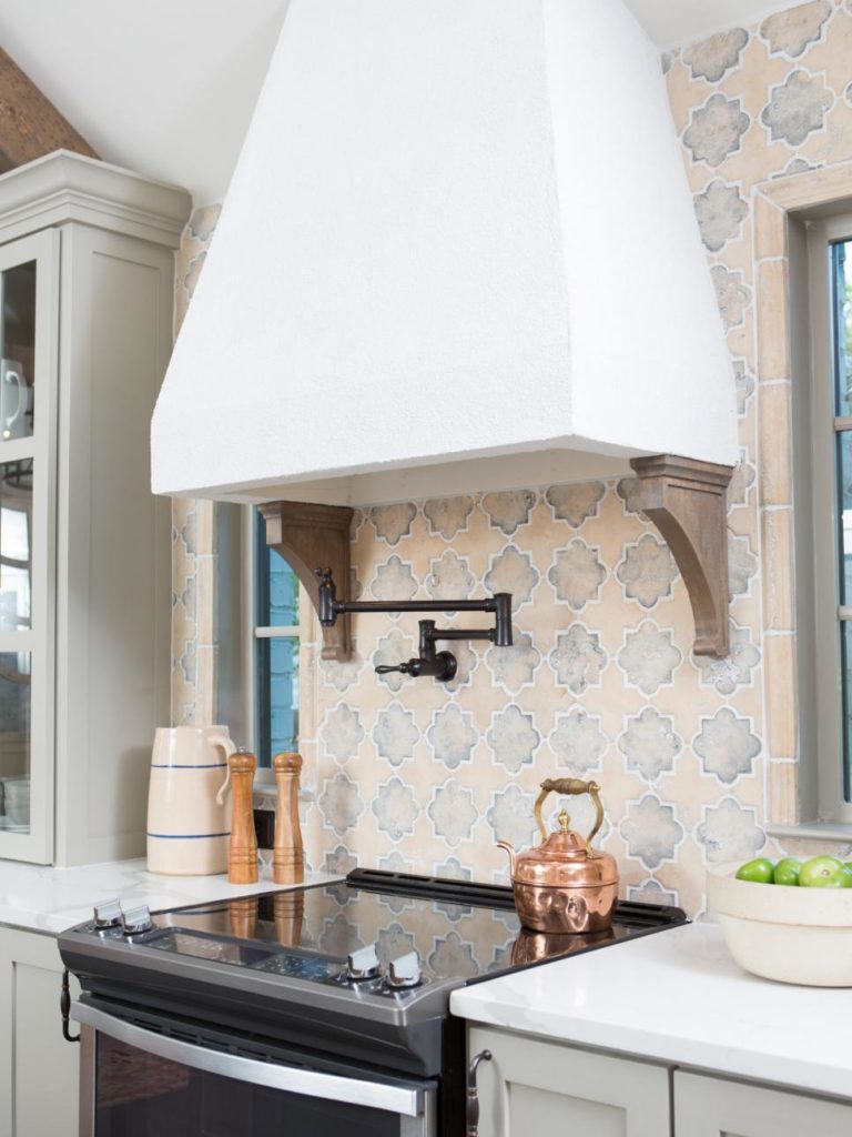 Fixer Upper Hot Sauce House kitchen features a hood vent that helps create a rustic Italian feel that the Ignacio’s wished for www.PattersonDecoratingGroup.com/blog
