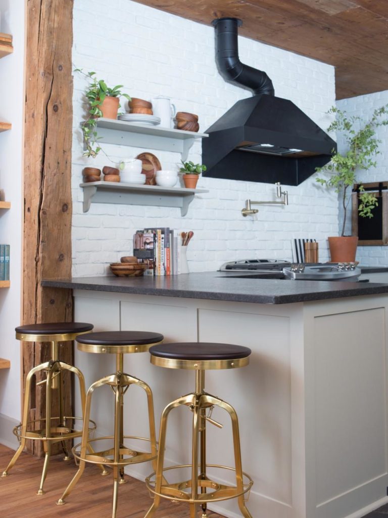 Gold bar stools provide extra seating at this peninsula counter in this Fixer Upper kitchen www.PattersonDecoratingGroup.com/blog